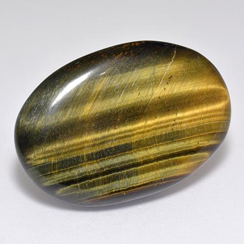 Tiger's Eye طبيعي بلون بنى دافئ، وزن ‎23.65‎ قيراط، شكل بيضاوى، مقاس ‎27.6x19‎ مم